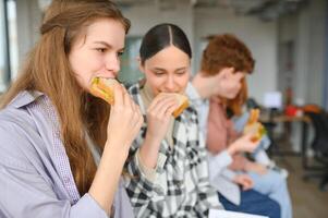 Pupils having lunch in classroom photo