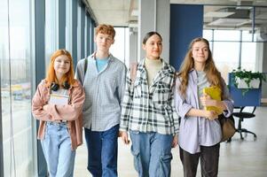Happy diverse college students posing for group portrait, looking at camera, smiling photo