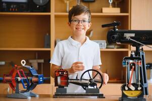Physics lesson. A student at a desk with scientific instruments and a telescope photo