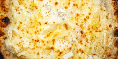 pizza four types of cheese mozzarella, blue cheese, camembert and cheddar fresh meal food snack on the table copy space food background rustic top view photo