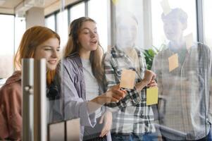 students discuss university assignments together photo