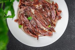 anchovies in a plate on the table canned fish in oil fresh and tasty seafood meal food snack on the table copy space food background rustic photo