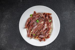 anchovies in a plate on the table canned fish in oil fresh and tasty seafood meal food snack on the table copy space food background rustic photo