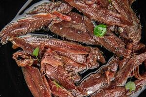 anchovies in a plate on the table canned fish in oil fresh and tasty seafood meal food snack on the table copy space food background rustic photo
