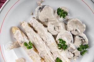 white asparagus in cream sauce fresh meal food snack on the table copy space food background rustic top view photo