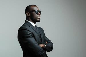 A black man in a business suit stands on a white background in the pose of a boss. Generated by artificial intelligence photo