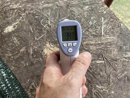 Measuring temperature with a non-contact thermometer photo