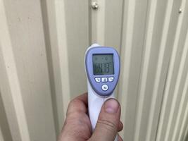 Measuring temperature with a non-contact thermometer photo