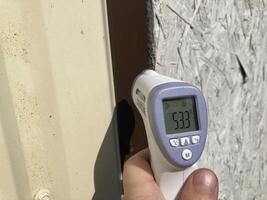 Measuring temperature with a non-contact thermometer photo
