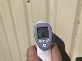 Measuring temperature with a non-contact thermometer photo