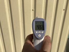 Measuring temperature with a non-contact thermometer photo