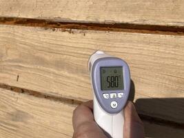Measuring temperature with a non-contact thermometer photo