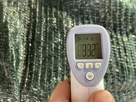 Measuring temperature with a non-contact thermometer photo