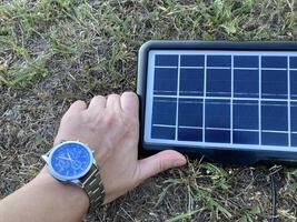Solar battery for charging your smartphone while hiking photo