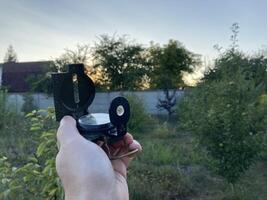 Compass for orientation on the terrain during a hike photo