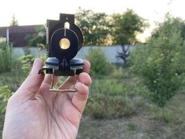 Compass for orientation on the terrain during a hike photo