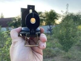 Compass for orientation on the terrain during a hike photo