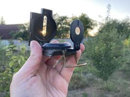 Compass for orientation on the terrain during a hike photo