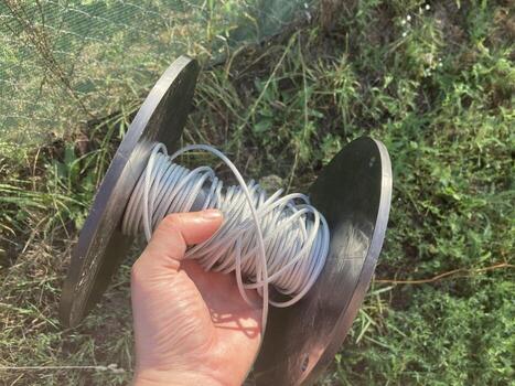 Strengthening a fence with a shading net with a rope photo