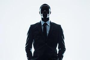 A black man in a business suit stands on a white background in the pose of a boss. Generated by artificial intelligence photo