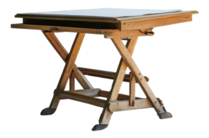 Vintage wooden drawing table with a folding design in a bright setting, cut out - stock . png