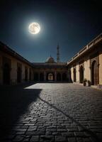 the moon is shining brightly in the night sky over an empty courtyard photo