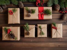 Christmas gift boxes, wrapped in brown kraft paper and tied with string, arranged on a wooden table with pine cones and green leaves. photo