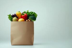 paper bag filled groceries healthy food fruit and vegetables on isolated backgroud. photo