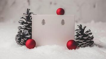 christmas blank greeting card mockup with small red and gray pine cones snowy simple background photo