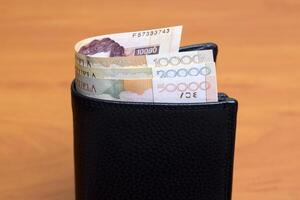 Old Venezuelan bolivar in the black wallet photo