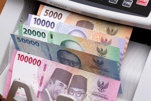 Indonesian rupiah in the counting machine photo