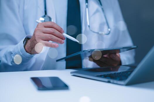 A doctor is using a tablet and a pen to take notes. The tablet is open to a page with a lot of information on it. The doctor is focused on the tablet photo