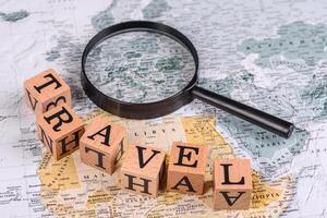 Conceptual background for travel with passport, magnifying glass, world map and money photo