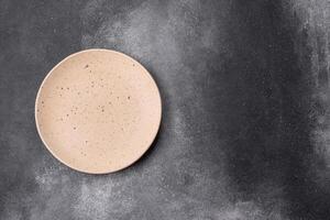 Empty ceramic plate on a dark textured background photo