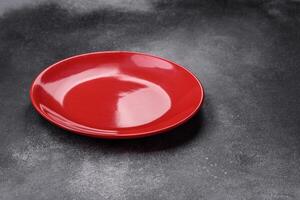 Empty ceramic plate on a dark textured background photo