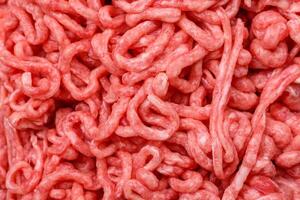 Fresh raw ground beef with salt and spices photo