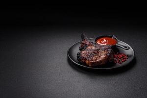 Juicy grilled beef tomahawk steak with salt, spices and herbs photo