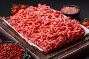 Fresh raw ground beef with salt and spices photo