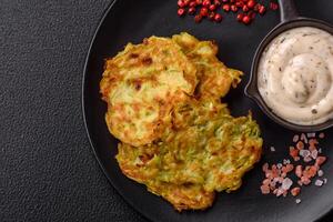 Vegetable zucchini fritters with garlic, salt, spices and herbs photo