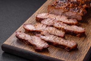 Fresh juicy delicious beef steak on a dark background photo