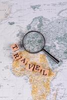 Conceptual background for travel with passport, magnifying glass, world map and money photo