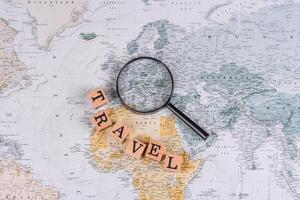 Conceptual background for travel with passport, magnifying glass, world map and money photo