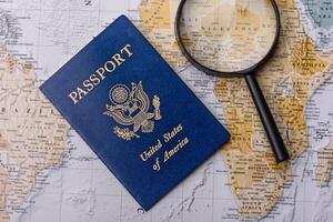 Conceptual background for travel with passport, magnifying glass, world map and money photo