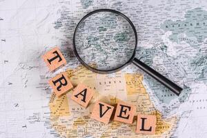 Conceptual background for travel with passport, magnifying glass, world map and money photo