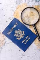 Conceptual background for travel with passport, magnifying glass, world map and money photo