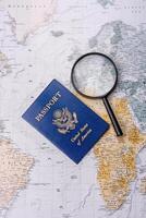 Conceptual background for travel with passport, magnifying glass, world map and money photo