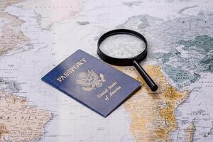 Conceptual background for travel with passport, magnifying glass, world map and money photo