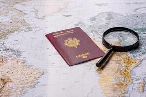 Conceptual background for travel with passport, magnifying glass, world map and money photo