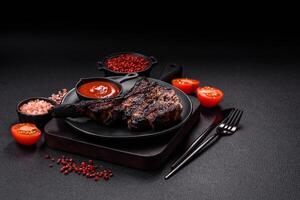 Juicy grilled beef tomahawk steak with salt, spices and herbs photo
