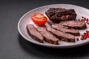 Fresh juicy delicious beef steak on a dark background photo